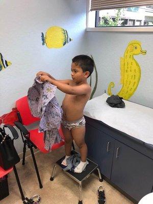 My son putting his gown for his check up!!!