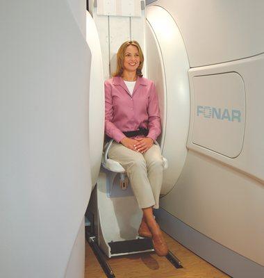 SUMA MRI patient sitting for an open upright MRI scan.