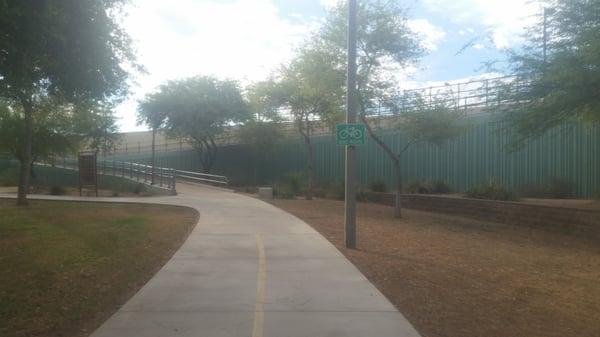 Bike route cuts through the park connected by a pedestrian bridge