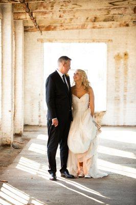 Couple looking lovingly at eachother in industrial space. Photo by Ciao Bella Studios.