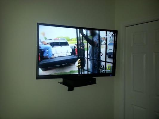 TV and shelf on wall installation with hidden electrical service.