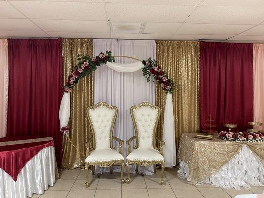 Wedding, burgundy and gold with roses.