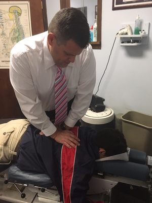 Dr. Ed Stockli performing a back adjustment.