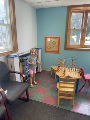 My daughter playing with all the fun toys in the waiting room!