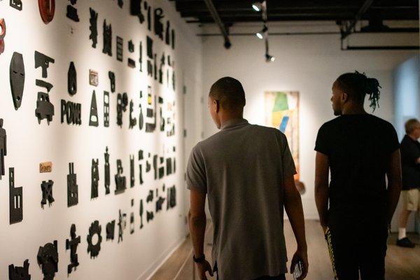 Visitors admiring artworks on view for "Off the Wall: Sculpture from the Mott-Warsh Collection." Exhibit runs through January 25, 2020.