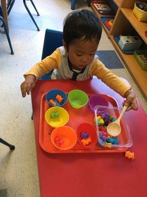 One of our students working very hard with one of the Montessori activities.