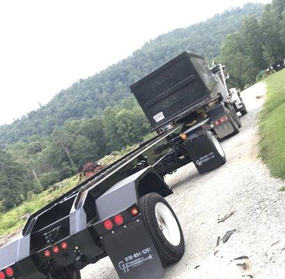 Flexing our dumpster truck. Our bins and trucks can hold any large household objects such as carpet, wood, furniture, rugs, and etc.