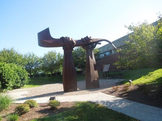 The companion book to this memorial is visible behind and to the right of the sculpture