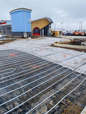 Tommy's Car Wash with the radiant tube heating blanket, steel grid, and piping for the heated parking lot.