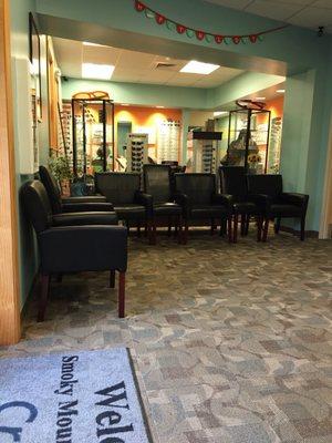 Waiting room. Comfy chairs. Shopping for glasses is behind chairs.