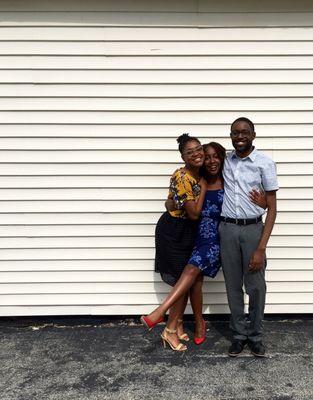 Two of my sisters and I pose for a photo on the side of the church.