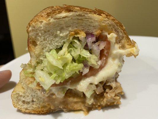 Buffalo chicken cheesesteak with lettuce onions tomatoes