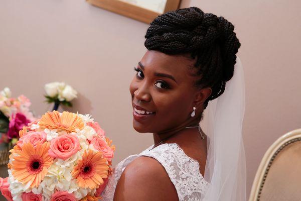 Bright peach daisies, white hydrangeas, and coral rose bouquet