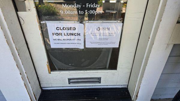 Sign saying ring the doorbell, however they are closed for lunch.