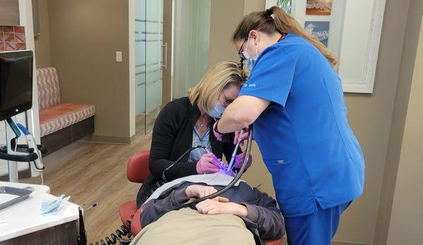 Dr. Fortney and her assistant work on my daughter's teeth.