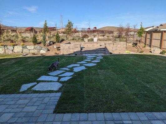 Patio extension, rock walk way through grass and a fire pit.