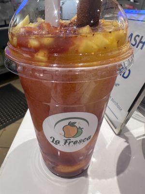 Mangonada made with mango slushy, mangos, tajin, lime.