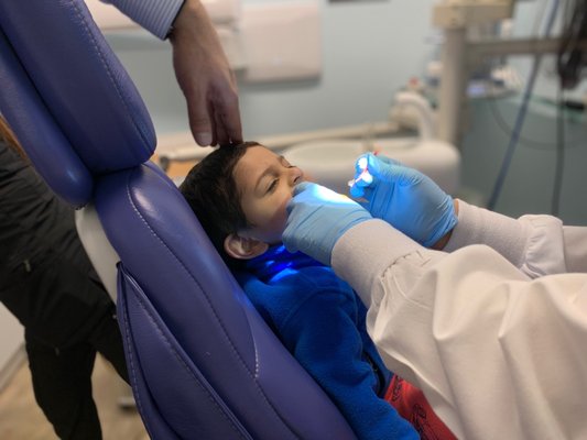 2 year old having fun getting his teeth cleaned