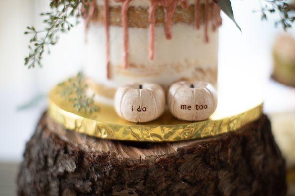 A closer view of our cake.. we wanted the "naked" design with a rose gold drip from the top. (pumpkins in front were provided by myself)