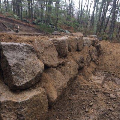 Stacked boulder retaining wall