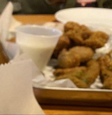 Appetizer of fried green beans and chicken gizzards with ranch and honey mustard dressing.