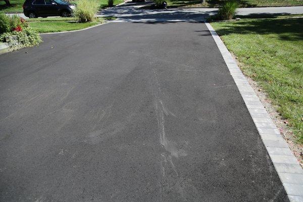 Drag marks from a hose left by Opal on my driveway