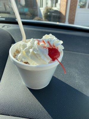 Small sundae with vanilla , death by chocolate with whipped cream and cherry on top