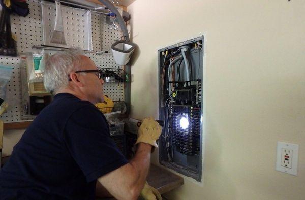 Marcel checking on a house's wiring