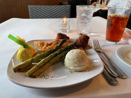 Fried Catfish, cheese grits and asparagus with hush puppies.