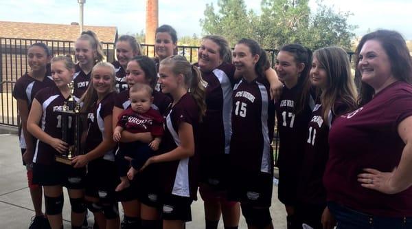 The Lady Warriors post volleyball game...with our little mascot.