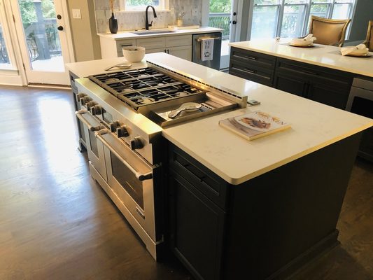 A gourmet kitchen with custom cabinets and beautiful white granite Counter tabs.