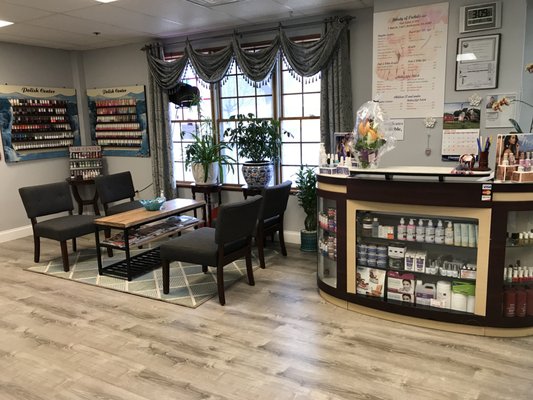 Convenient waiting area with comfortable cushion chairs with sleek designed coffee table in the middle.