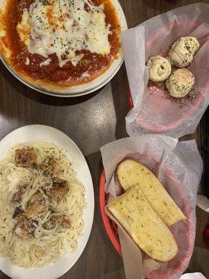 Baked lasagna and Garlic knots. Chicken Alfredo with bread