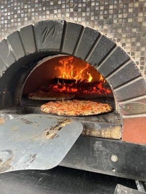 Fire-grilled custom gourmet pizza truck.