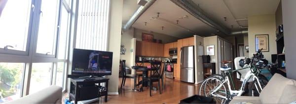 Panoramic while laying on the couch. Balcony with sliding door closer to the table & chairs.  Floor to ceiling windows.