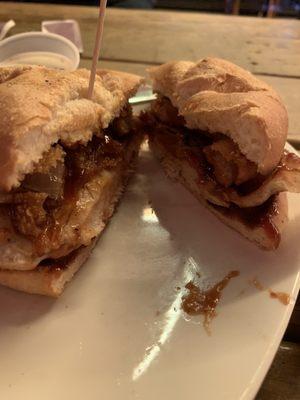 Cowboy chicken sandwich with BBQ sauce, bacon, and onion rings