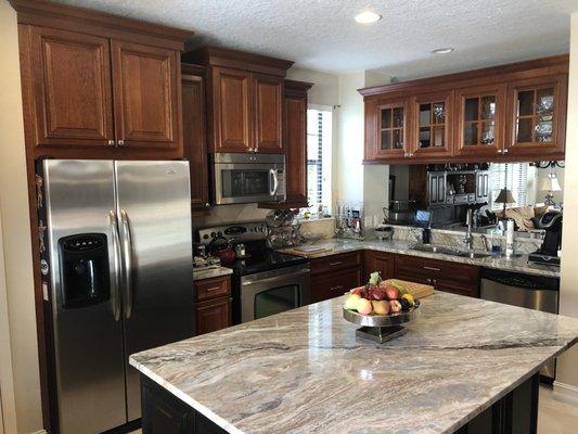 Rich dark brown kitchen with granite tops