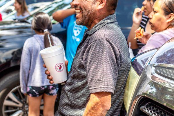 La Real Michoacana customer with an agua fresca (real fruit fresh water)