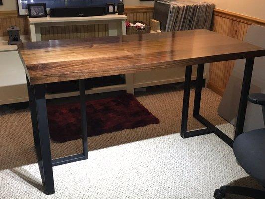 Slab walnut desk mounted on powder coated custom welded legs.