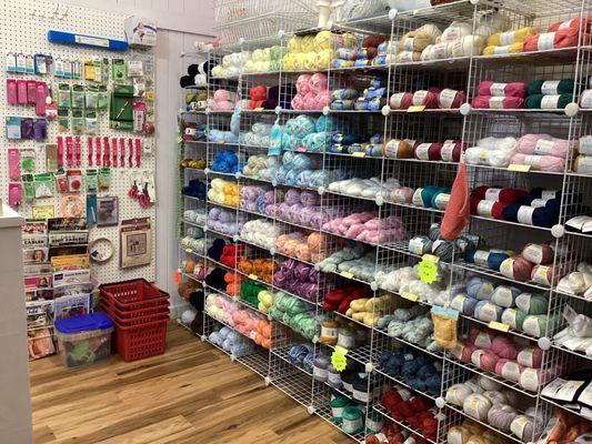 A variety of name brand yarns for fingering to chunky, wool, cotton, acrylic, nylon, mohair and others. Plus needles and other accessoreis