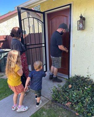 Unlocking and Opening the door for the first time after closing on their home.