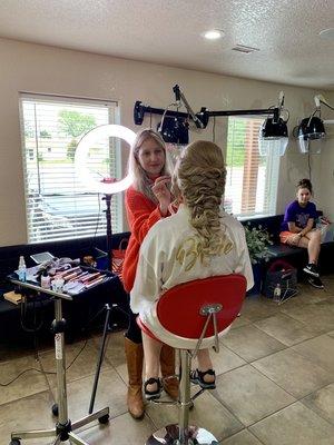 Bride getting her makeup done here for her wedding.