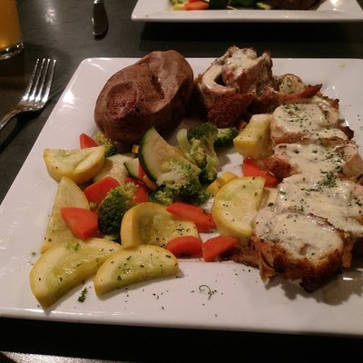 chicken cordon bleu, baked potato and vegetables