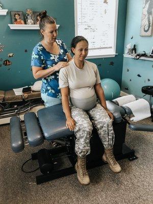 Dr. Beth adjusting an expecting mom