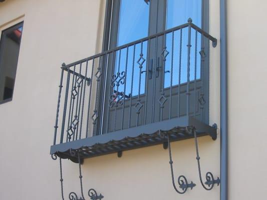 Decorative balcony with diamond shape design and scrolls