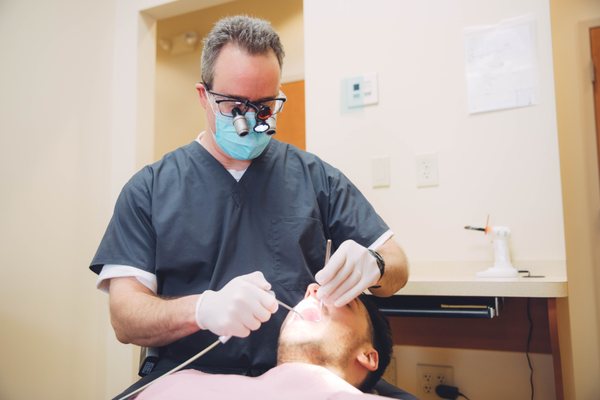 Dr. Dan Greenwood performing a dental procedure on a patient