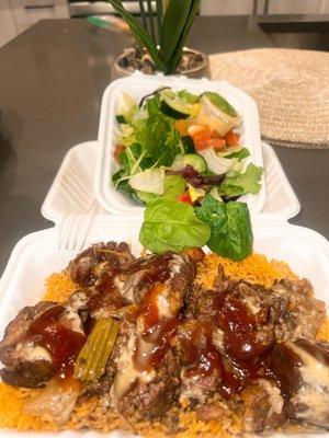 Oxtail bowl (over Jollof)  paired with a side salad