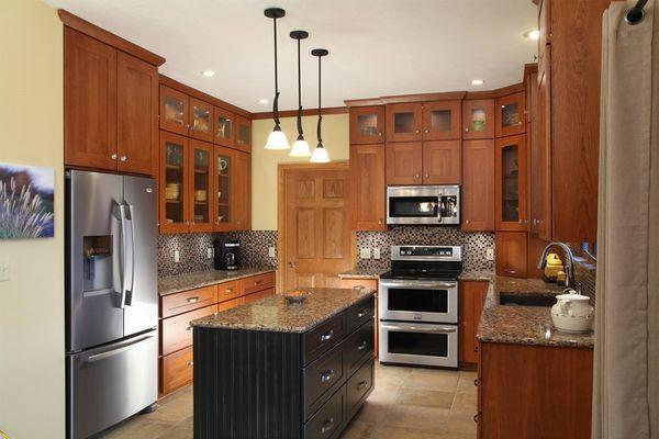 After: Cabinet refacing with Tuscan stain on Cherry perimeter with Distress Black island