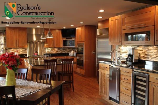 Open kitchen with an oversized island. Natural Cherry cabinets with granite countertop & glass tile backsplash.