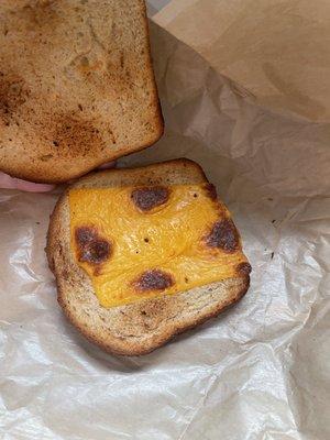 My kid's grilled cheese, uncut and with one tiny piece of burnt cheese